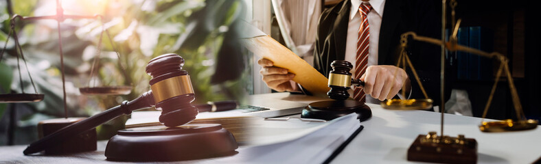 justice and law concept.Male judge in a courtroom on wooden table and Counselor or Male lawyer...