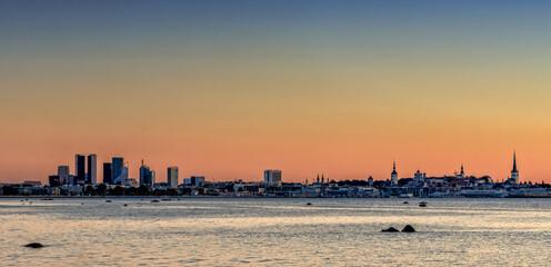 Fototapeta premium cityscape and skyline of Tallinn at sunset with colorful sky and copy space