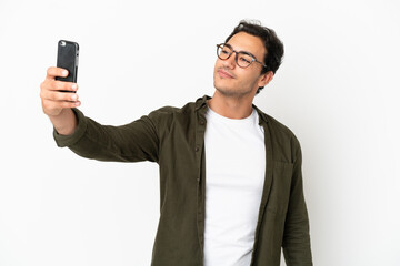 Caucasian handsome man over isolated white background making a selfie