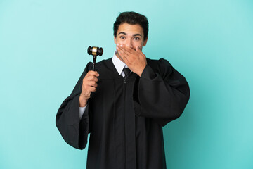 Naklejka premium Judge over isolated blue background happy and smiling covering mouth with hand