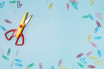 School supplies and paper clip on a blue background. Back to school concept. Precautions for COVID-19. Top view flat lay background. Copy space.