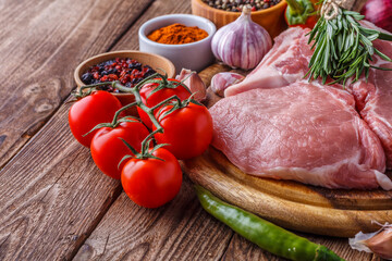 fresh raw new-york steak on wooden Board on wooden background with salt and pepper in a rustic style.