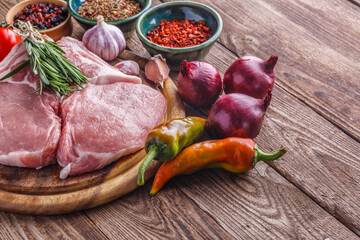 fresh raw new-york steak on wooden Board on wooden background with salt and pepper in a rustic style.