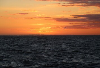 sunset over the sea with orange sky 