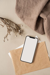 Flatlay of blank screen mobile phone, linen cloth on neutral beige background. Aesthetic home...