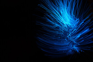 Blue abstract particles and lines with bokeh and blur in dark background.