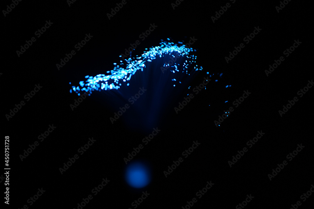 Wall mural blue abstract particles and lines with bokeh and blur in dark background.