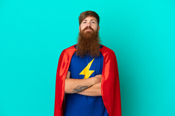 Redhead man in superhero costume with arms crossed
