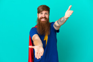 Redhead man in superhero costume and doing coming gesture