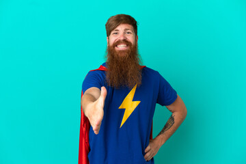 Redhead man in superhero costume and making a deal © luismolinero