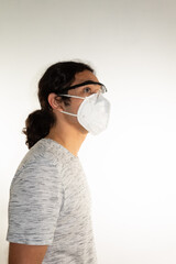 Hispanic man with long hair wearing a kn95 mask and protective glasses on a white background.