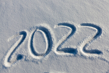 the inscription about the new year 2022 on the snow in winter