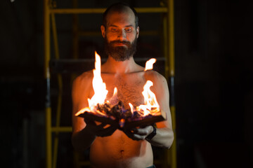 Man hold burning book in his hands