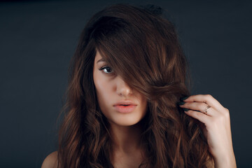 Portrait of beautiful young brunette woman with healthy hair.