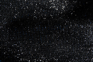 Fabric evening black dress girl with sequins, rhinestones. colorful sequined texture