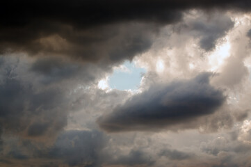 Fototapeta na wymiar Skrawek błękitne niebo prześwitujące zza chmur