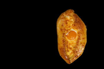 Ajarian khachapuri isolated on black. Hachapuri with copy space.