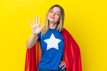 Super Hero Romanian woman isolated on yellow background counting five with fingers