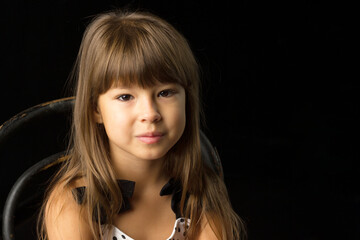 Fototapeta premium Beautiful happy girl sitting on chair