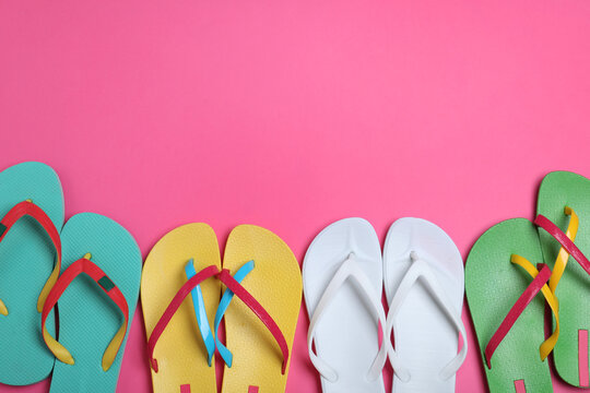 Many different flip flops on pink background, flat lay. Space for text