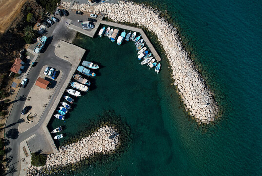 Aerial view of fishing boats and tourist yachts moored at the marina. Pomos harbor Paphos Cyprus