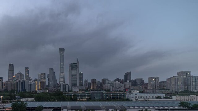 Downtown Beijing time lapse day to night transition panning left. Chinese metropolis central business district nightfall timelapse. Evening in capital financial district.