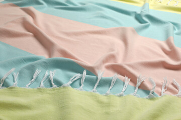 Crumpled colorful beach towel as background, closeup view