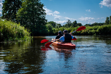 people kayaking on the Narew river in Podlasie, father and son, joint activity, two people, group...
