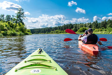 people kayaking on the Narew river in Podlasie, father and son, joint activity, two people, group rafting