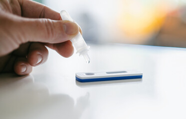 Man using a rapid antigen test kit. Rapid antigen testing is a screening tool to help to detect Corona COVID-19 in people without any symptoms of Sars-CoV-2