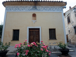 Fototapeta na wymiar ancient church facade with frescoes in a small village in the French Riviera back country