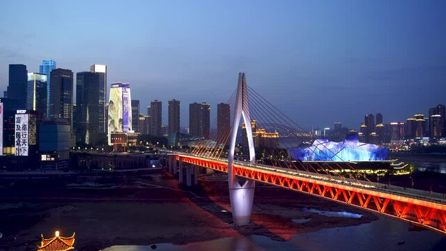 Chongqing bridge and grand theater at night. Low water drought conditions in the evening in major Chinese metropolis.