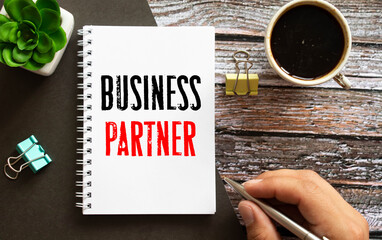 text BUSINESS PARTNER on white paper, concept