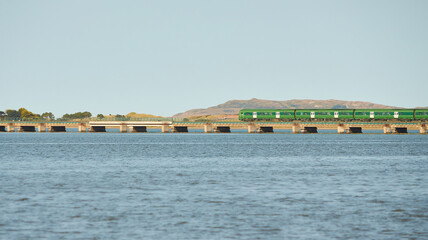 View from sea on the Malahide Bridge, railroad bridge with Dart train passing.