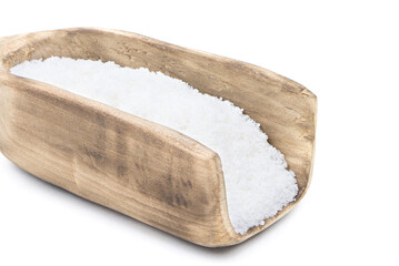 Salt in a wooden scoop isolated on a white background