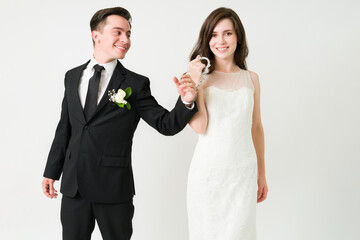 Bride and groom wearing handcuffs