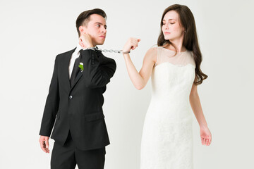 Upset young couple wearing handcuffs