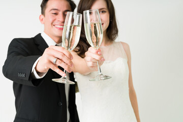 Bride and groom drinking champagne