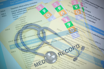 ICD-10 code book with medical record folder.