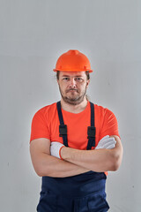 a serious worker in special clothes stands