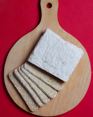 Tempe isolated on plain background. View from above. Tempe is a typical Indonesian food made from fermented soybean seeds. Tempe is rich in dietary fiber, calcium, B vitamins, and iron. Focus blur.