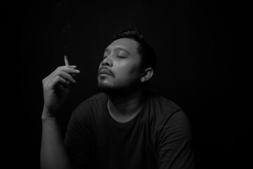 man smoking in the dark