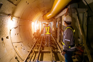 soft focus of Engineers wear helmet,vests safety .Technician control underground tunnel...