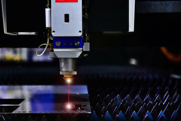 Industrial laser cut machine while cutting the sheet metal with the sparking light. free space on...