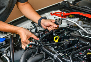 Fototapeta na wymiar Mechanic examining and maintenance the engine car , transportation repair service center