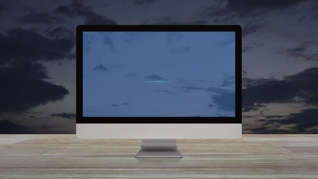 Bank flat icon on desktop modern computer monitor screen on wooden table over sunset sky, Business banking online concept