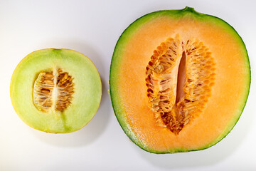 Half cut of different two varieties of net melon (Cucumis melo) harvested in home garden in Japan
