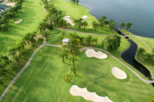 Aerial view of the green golf course in Thailand Beautiful green grass and trees on a golf field with fairway and putting green in summer season