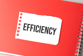 The word efficiency on torn paper on red notepad,.