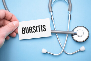 the doctor's hands holds a business card with the text of Bursitis with one hand and the other points to the text.
